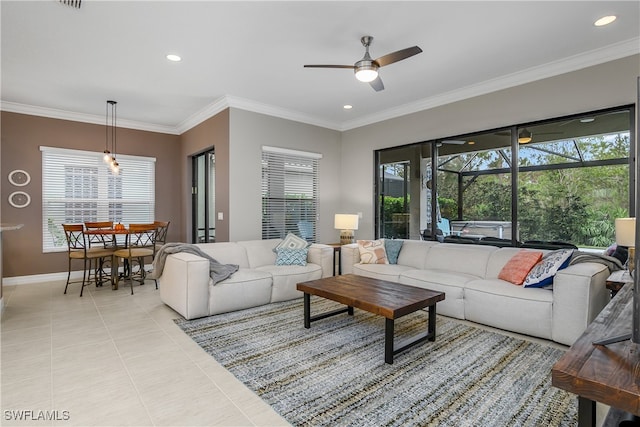 living room with ornamental molding, ceiling fan, and light tile patterned flooring