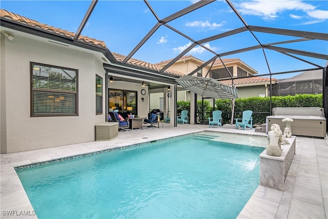 view of swimming pool with ceiling fan, a lanai, and a patio