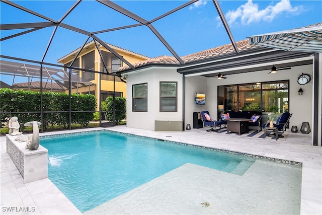 view of swimming pool with ceiling fan, a lanai, and a patio area