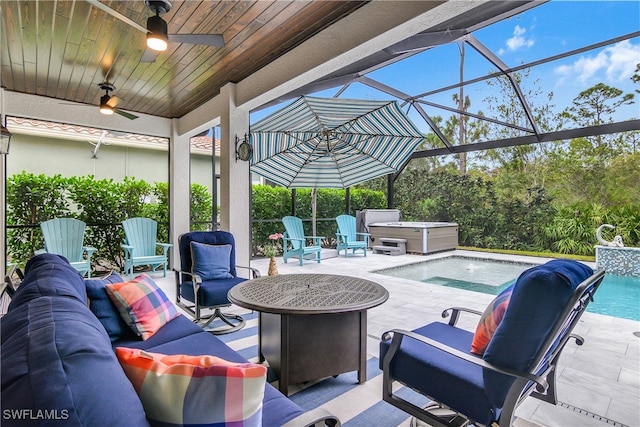 view of patio featuring an outdoor living space with a fire pit, a swimming pool with hot tub, a lanai, and ceiling fan