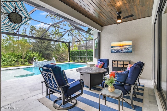 view of patio featuring ceiling fan, a lanai, and pool water feature