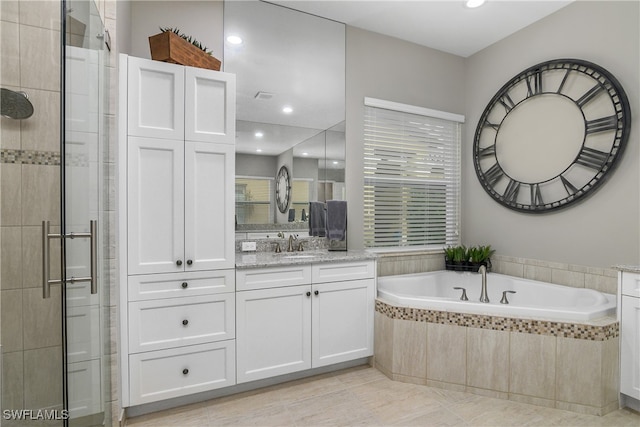 bathroom featuring vanity, tile patterned floors, and separate shower and tub