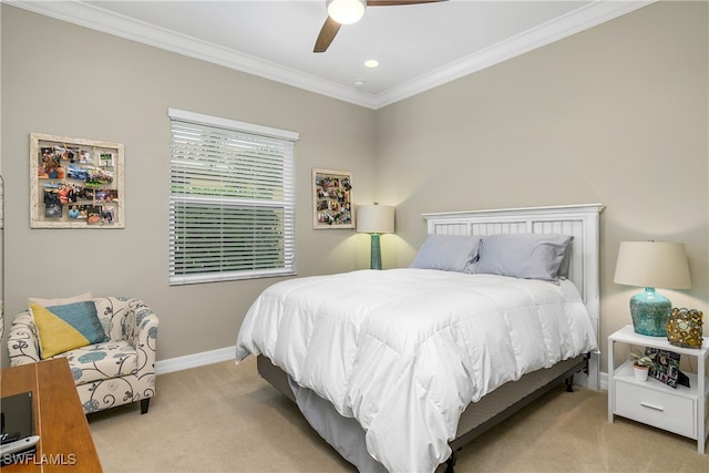 carpeted bedroom featuring ceiling fan and crown molding