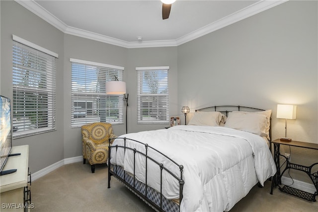 bedroom with carpet flooring, ceiling fan, and crown molding