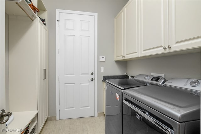 laundry area featuring cabinets and washer and dryer