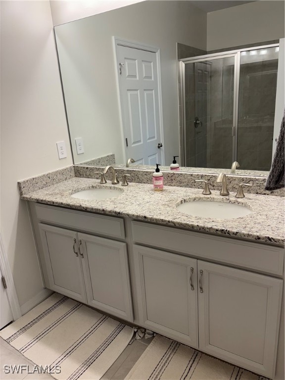 bathroom with walk in shower and vanity