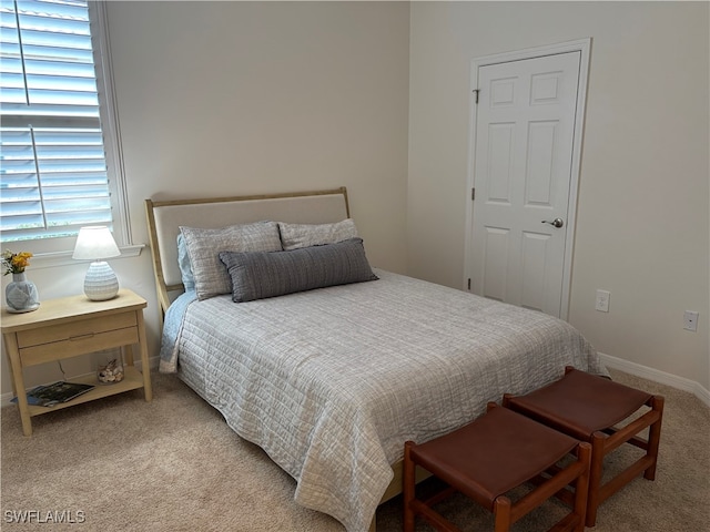 bedroom featuring light colored carpet