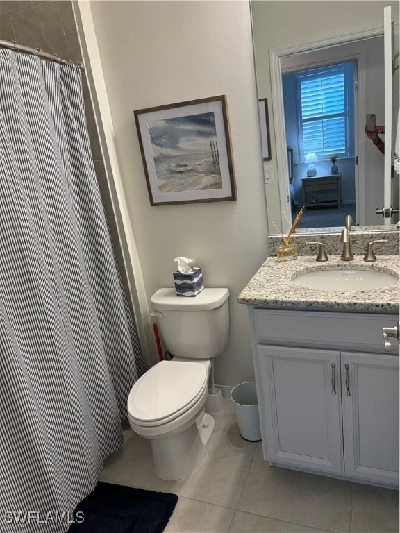 bathroom featuring a shower with curtain, tile patterned flooring, vanity, and toilet