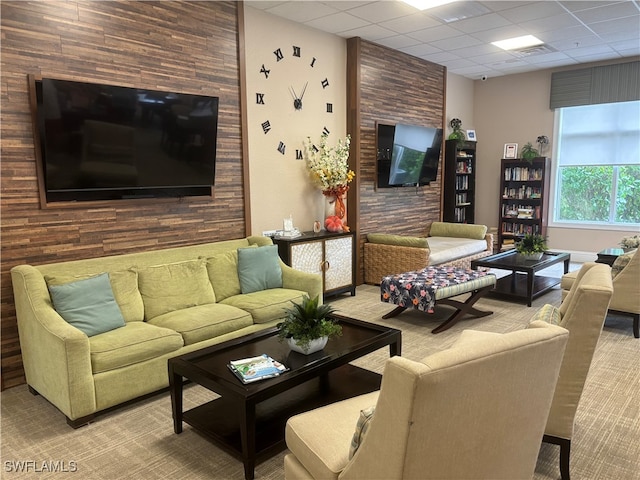 living room with carpet and a drop ceiling