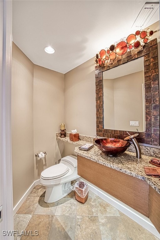 bathroom featuring vanity and toilet