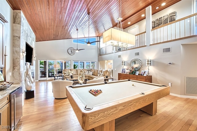 playroom featuring high vaulted ceiling, light hardwood / wood-style floors, ceiling fan, and wooden ceiling