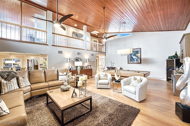 living room with high vaulted ceiling, light hardwood / wood-style floors, and plenty of natural light