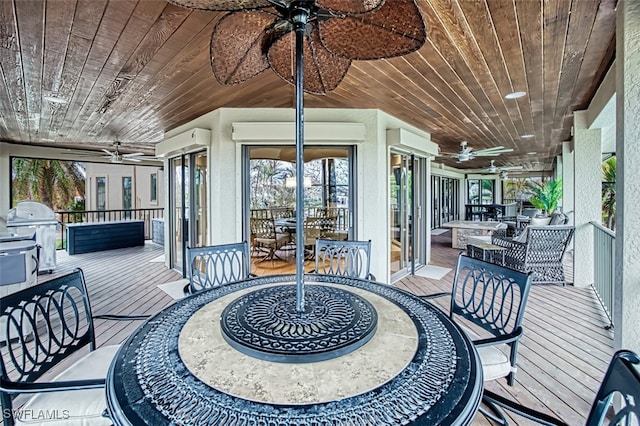 sunroom / solarium with wood ceiling and ceiling fan