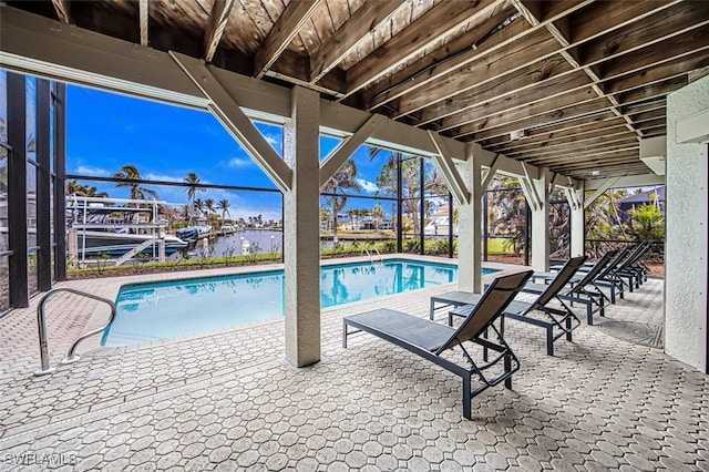 view of pool with a patio and a lanai