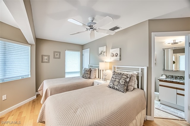 bedroom with multiple windows, light wood-type flooring, and ceiling fan