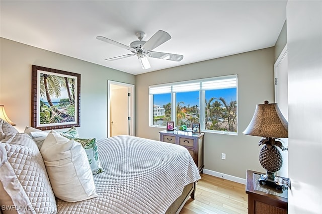 bedroom with ceiling fan and light hardwood / wood-style floors