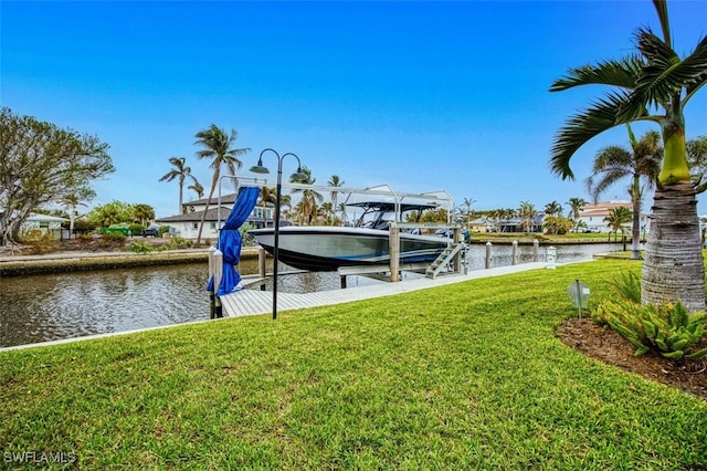 dock area featuring a yard and a water view