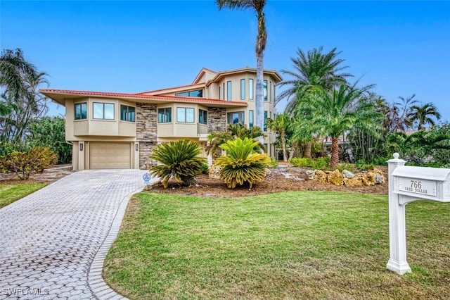 view of front of house featuring a garage and a front lawn