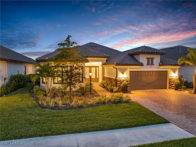 view of front facade with a yard and a garage