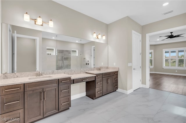 bathroom featuring ceiling fan, a tile shower, wood-type flooring, and vanity