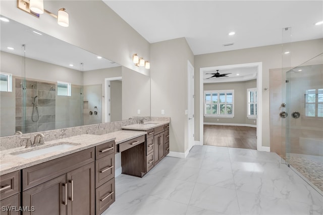 bathroom featuring a tile shower, vanity, ceiling fan, and wood-type flooring