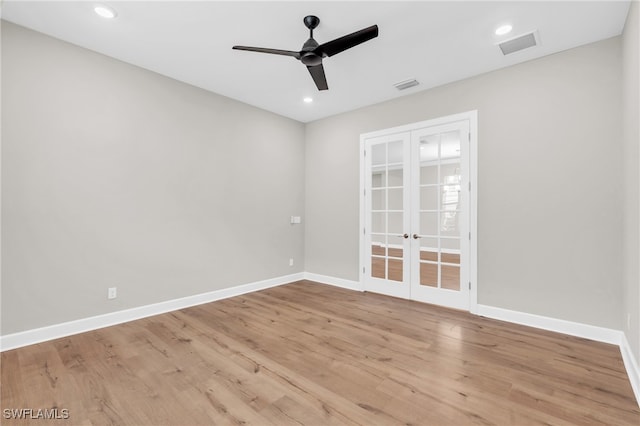 unfurnished room featuring ceiling fan, light wood-type flooring, and french doors