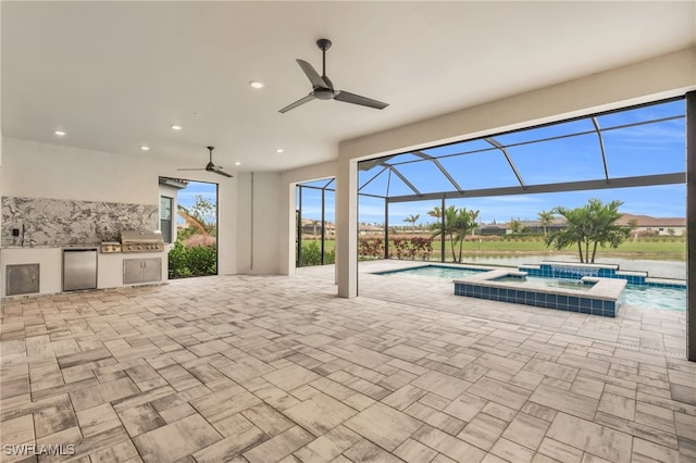 view of patio featuring area for grilling, ceiling fan, exterior kitchen, a swimming pool with hot tub, and glass enclosure