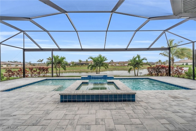 view of pool featuring an in ground hot tub, a water view, glass enclosure, and a patio area