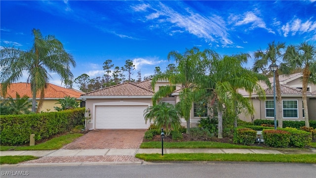 mediterranean / spanish-style house with a garage