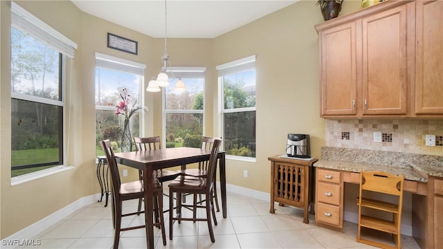 dining room with light tile patterned floors and a notable chandelier