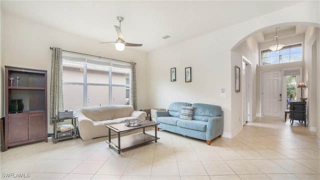 tiled living room with ceiling fan