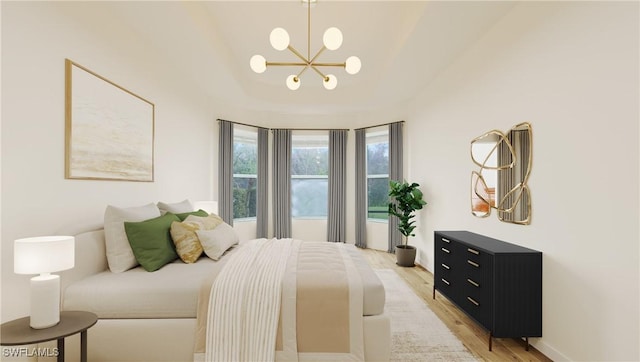 bedroom featuring light hardwood / wood-style floors and a notable chandelier