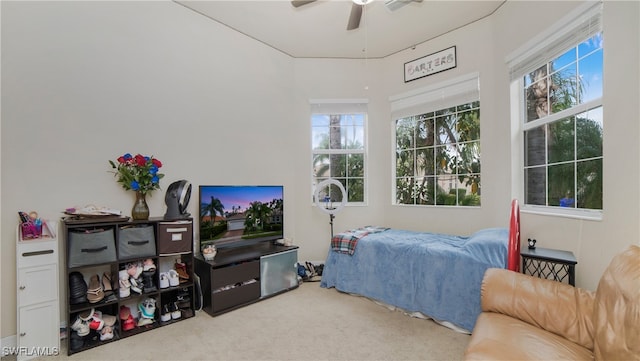 carpeted bedroom featuring ceiling fan and multiple windows