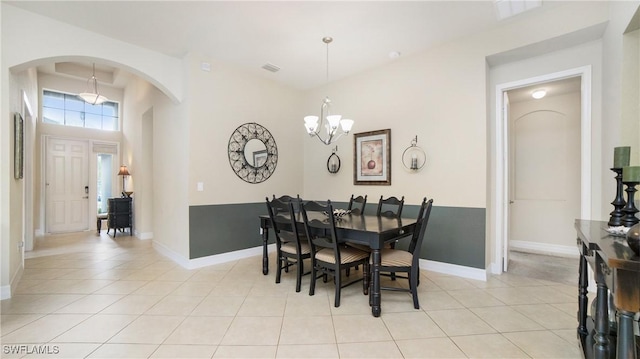 tiled dining area featuring a notable chandelier