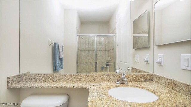 bathroom with an enclosed shower and vanity