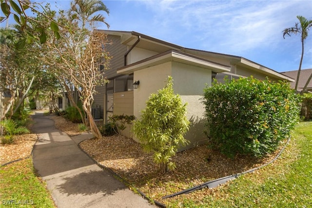 13366 Fox Chapel Ct, Fort Myers, FL 33919 - view of home's exterior featuring stucco siding and a central AC unit