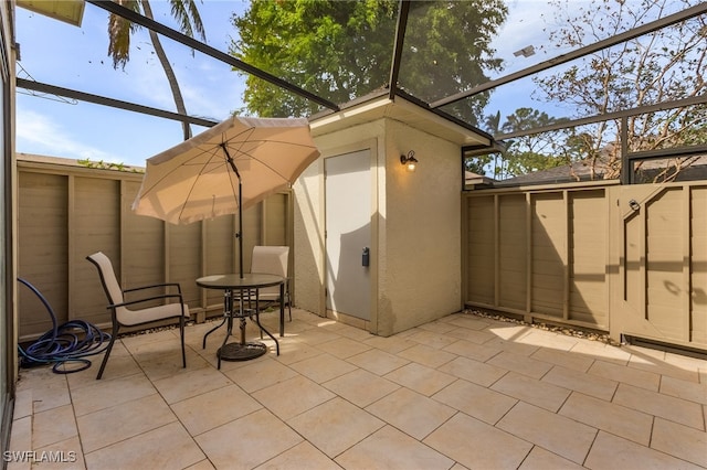 view of patio featuring a lanai