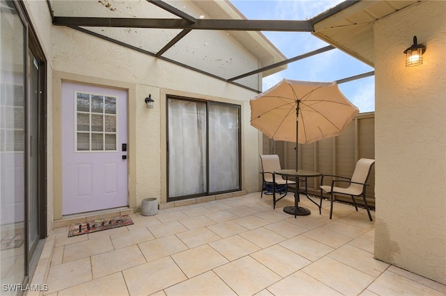 view of patio featuring a lanai