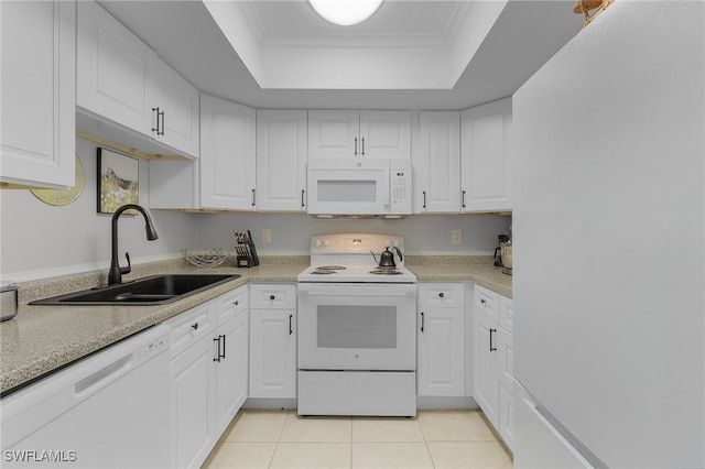 kitchen with white cabinets, white appliances, sink, and a tray ceiling