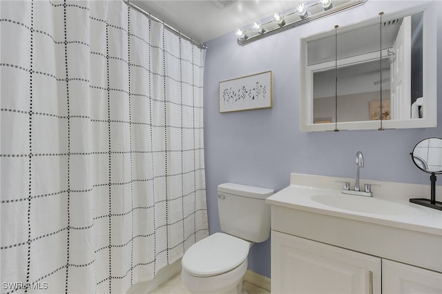 bathroom featuring vanity, toilet, and a shower with curtain