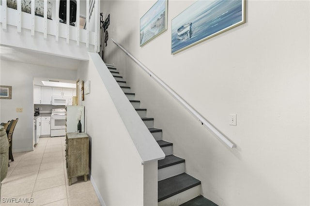 stairway featuring tile patterned flooring