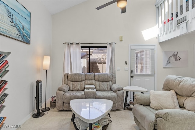 tiled living room with high vaulted ceiling and ceiling fan