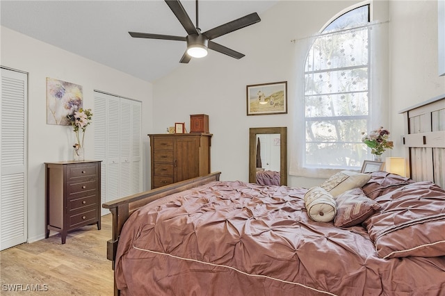 bedroom with multiple windows, two closets, and light hardwood / wood-style floors