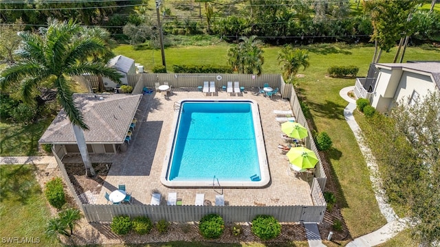 view of swimming pool featuring a patio and a yard