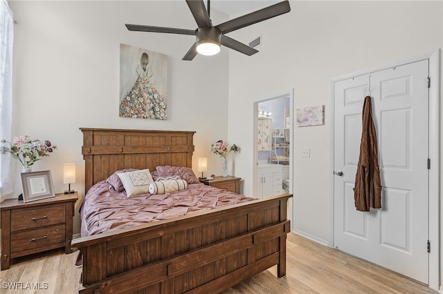 bedroom with ensuite bathroom, ceiling fan, and light wood-type flooring