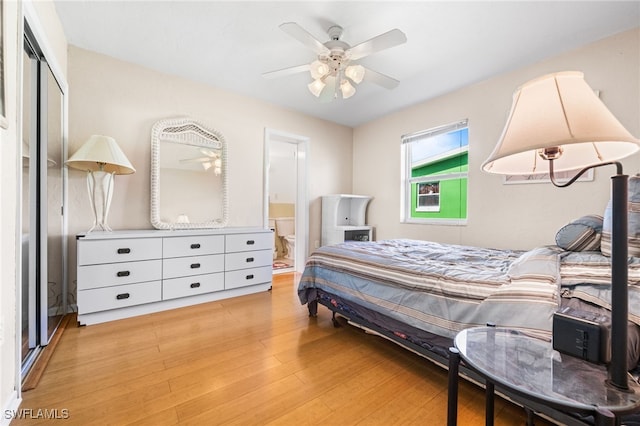 bedroom featuring a closet, connected bathroom, ceiling fan, and light hardwood / wood-style flooring