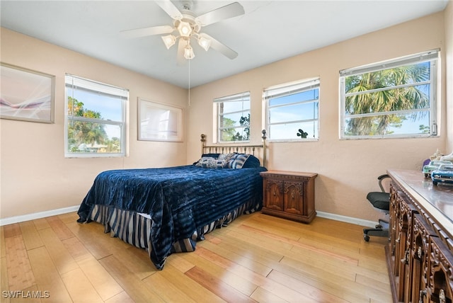 bedroom with ceiling fan and light hardwood / wood-style floors