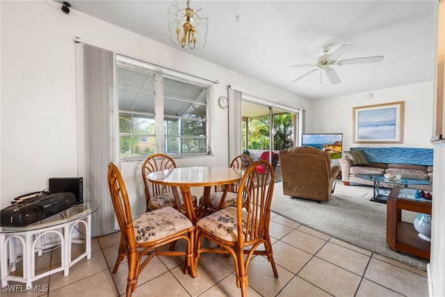 dining space with light tile patterned floors and ceiling fan