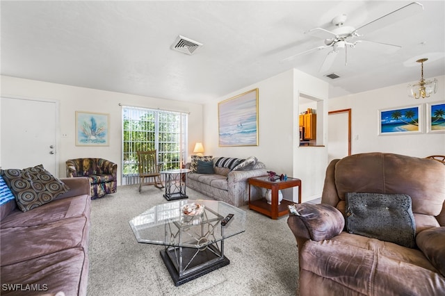 living room with ceiling fan with notable chandelier