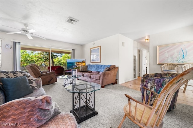 living room featuring light carpet and ceiling fan